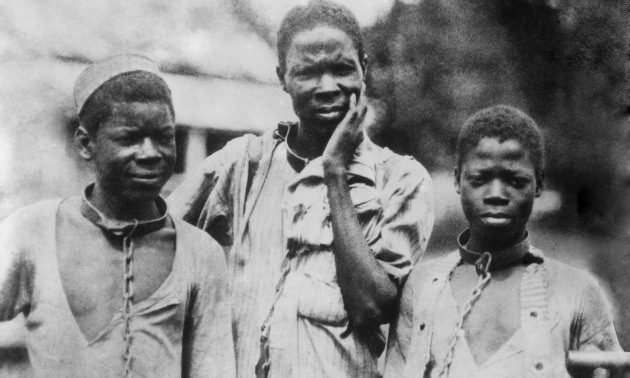 circa 1910: Three Abyssinian slaves in iron collars and chains. (Photo by Hulton Archive/Getty Images)